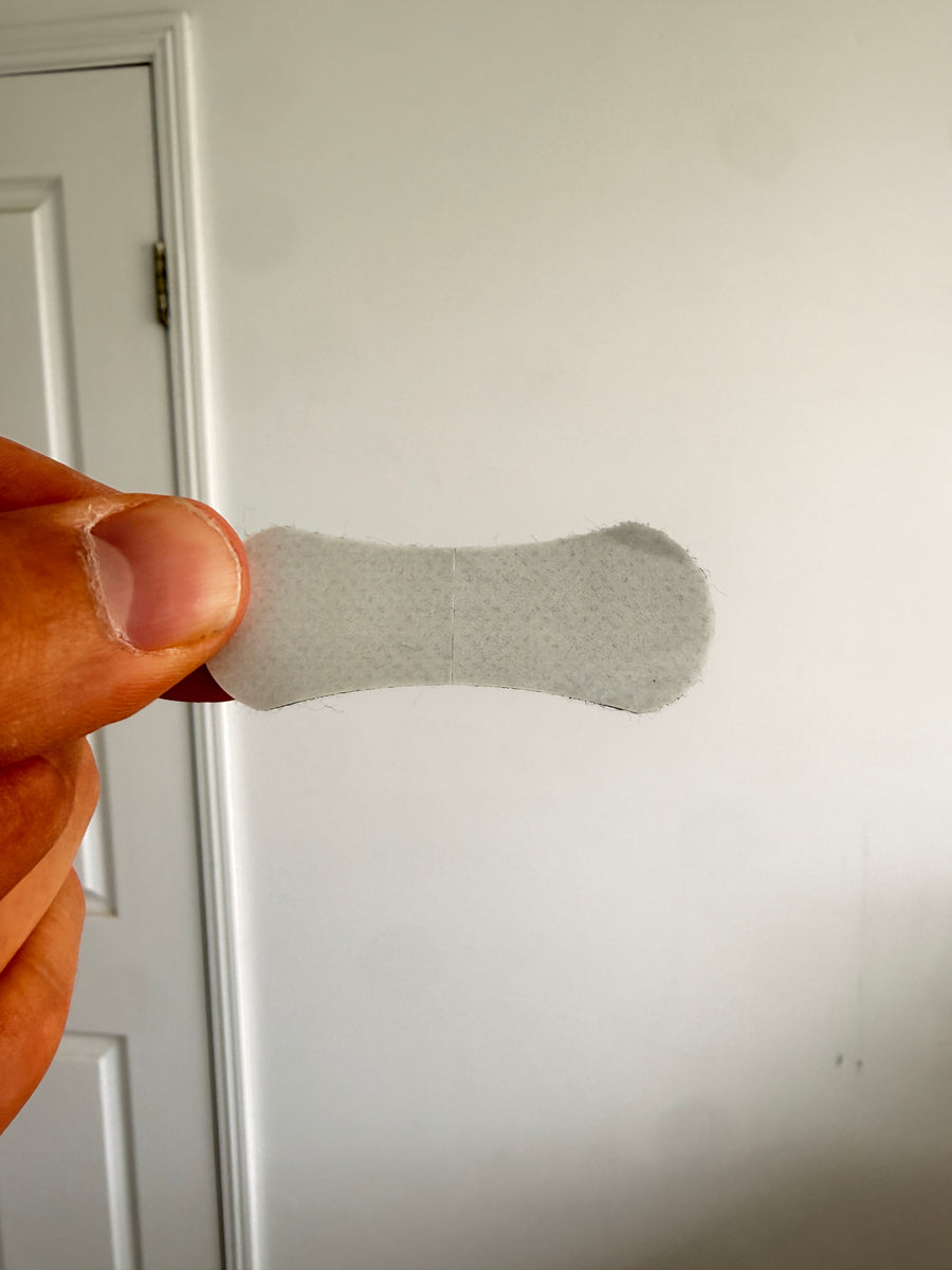A single mouth tape strip held between fingers