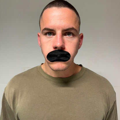 Real person wearing black mouth tape, front view